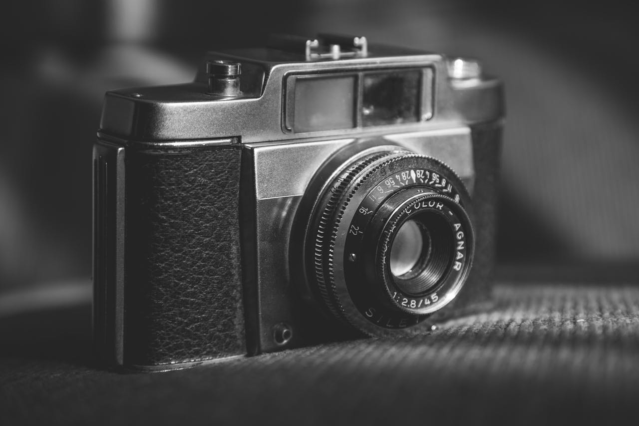Close-up of a vintage camera showcasing its classic design in black and white.